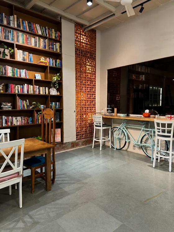 The room in daylight, shelves and brick